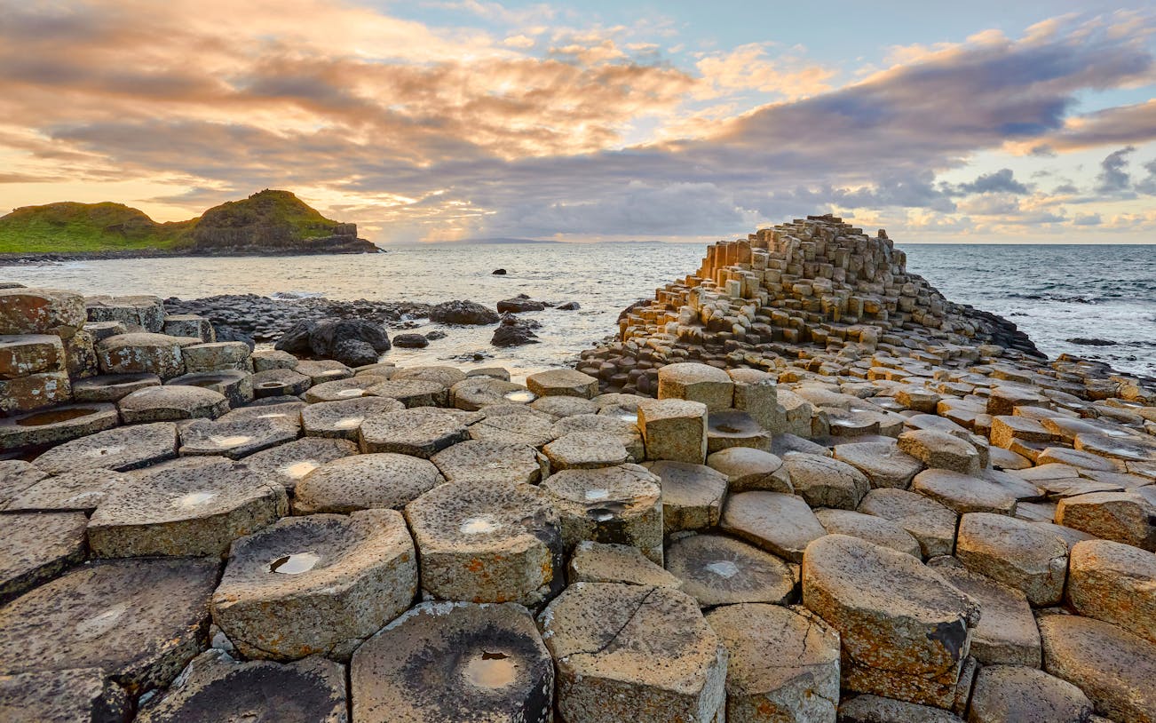 Giant's Causeway basalt columns by the sea at sunset, Northern Ireland.