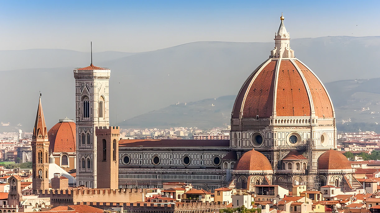 Florence Cathedral facade with tourists on guided tour.
