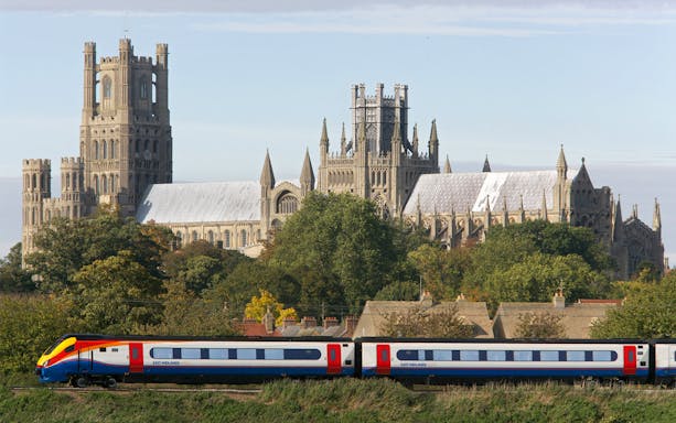 Eurail train passing Ely Cathedral in England.