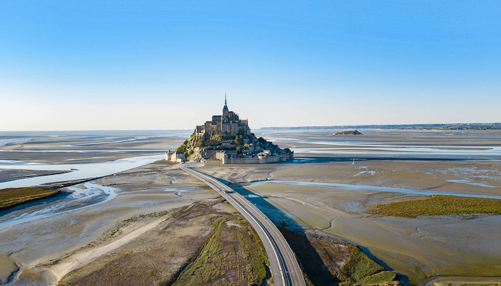 Aerial view of Mont Saint-Michel with connecting bridge, Normandy, France.