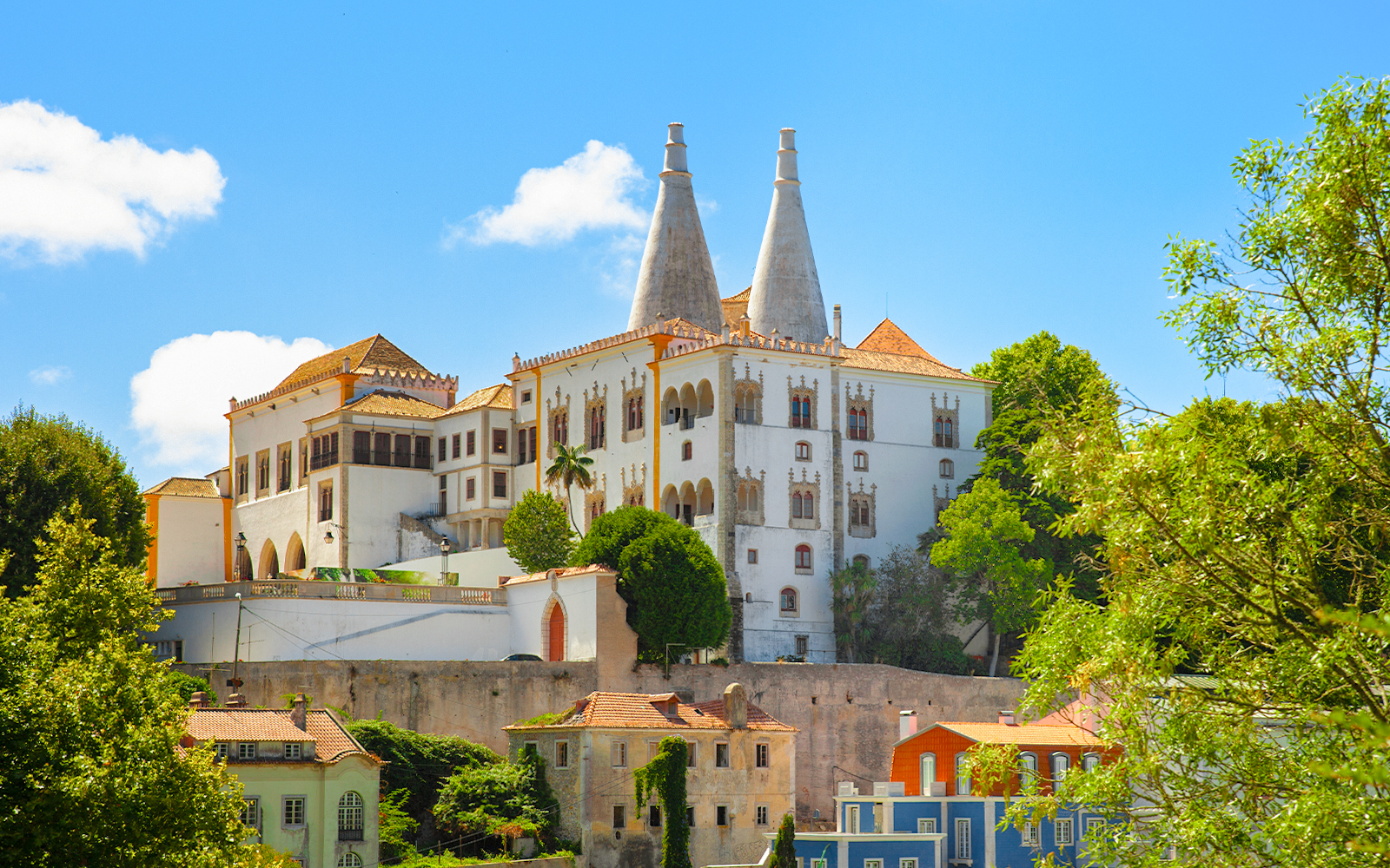 National Palace of Sintra exterior with twin chimneys and intricate architectural details in Sintra, Portugal.