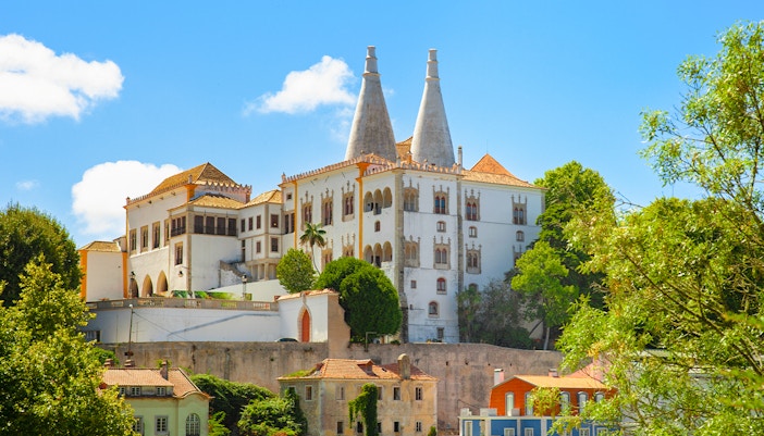 National Palace of Sintra exterior with twin chimneys and intricate architectural details in Sintra, Portugal.
