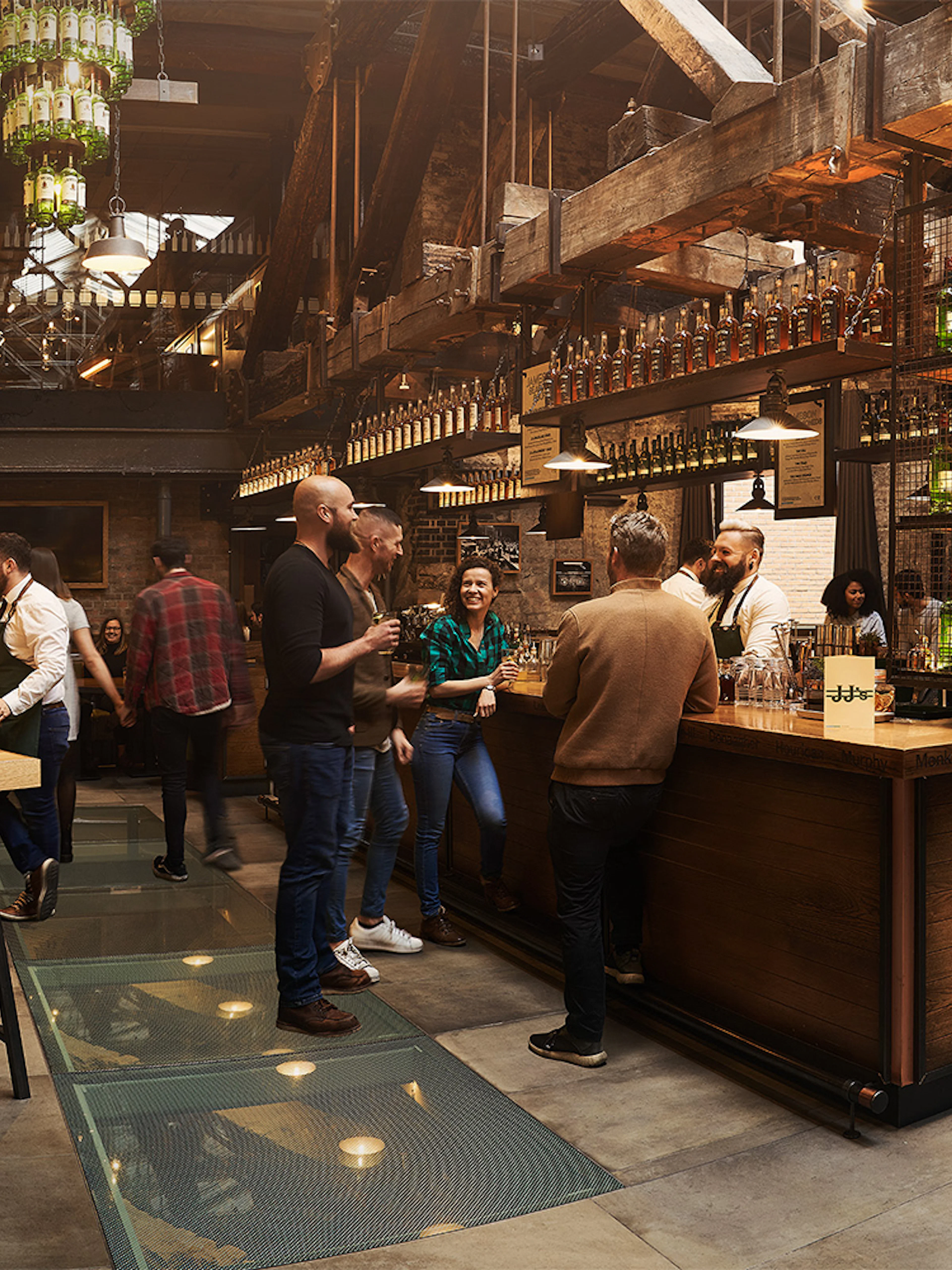 Visitors enjoying tastings at Jameson Whiskey Distillery bar in Dublin.