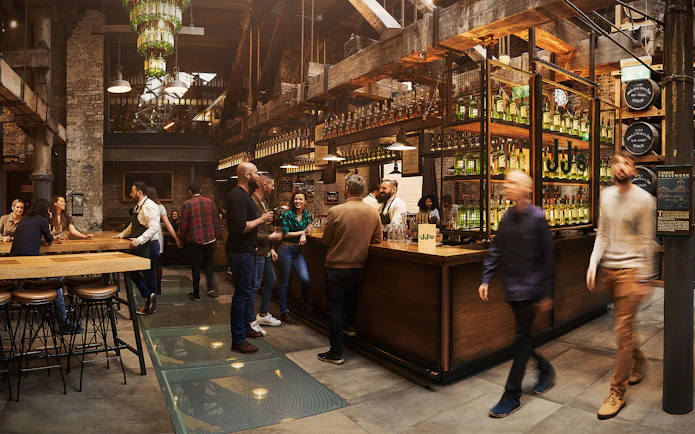 Visitors enjoying tastings at Jameson Whiskey Distillery bar in Dublin.