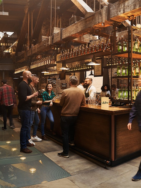 Visitors enjoying tastings at Jameson Whiskey Distillery bar in Dublin.