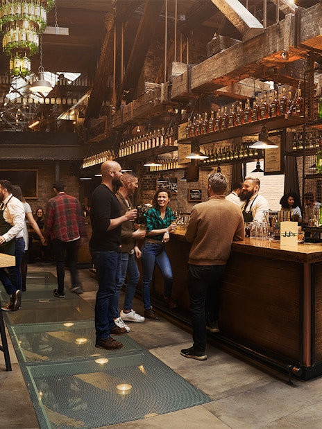 Visitors enjoying tastings at Jameson Whiskey Distillery bar in Dublin.