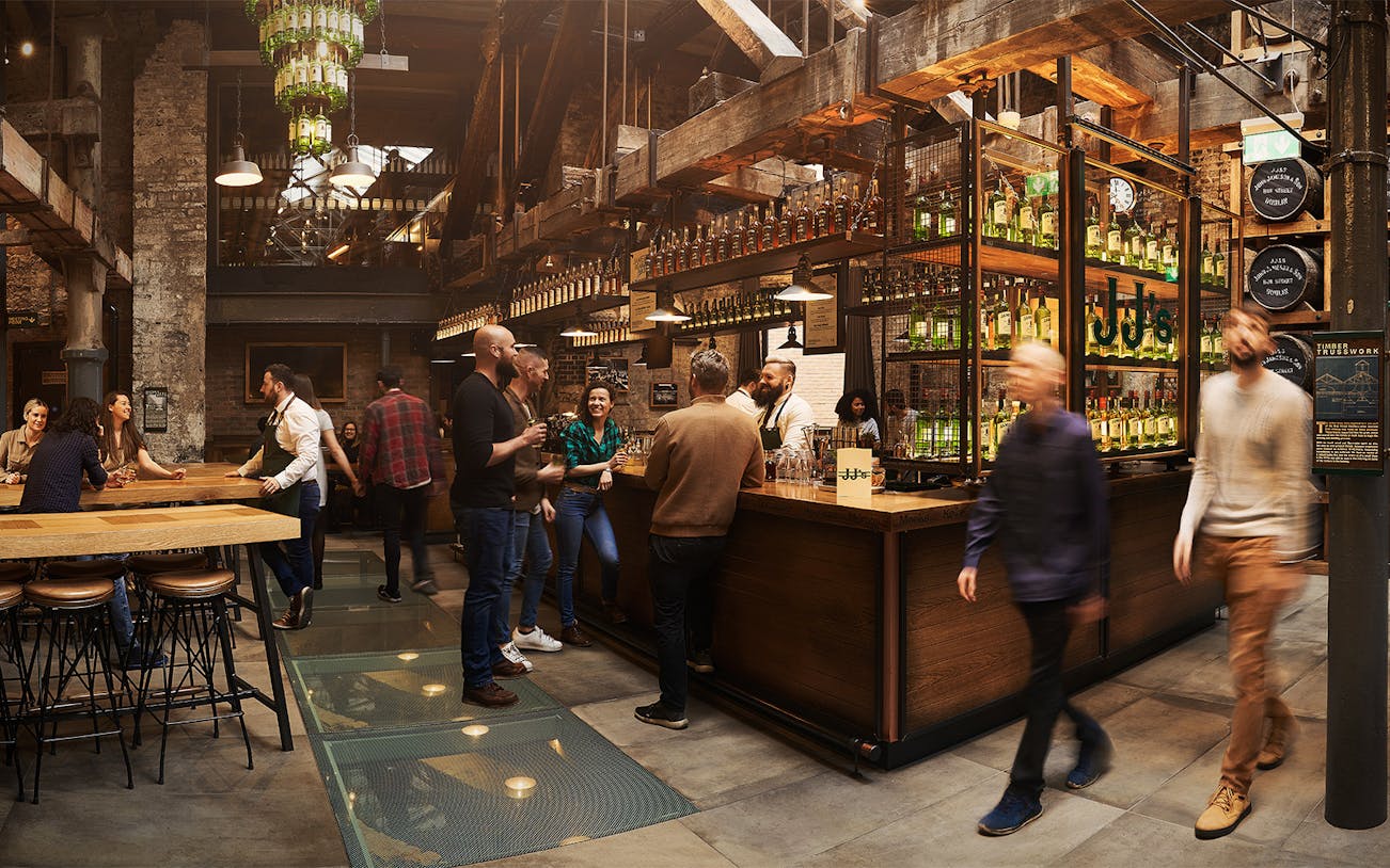 Visitors enjoying tastings at Jameson Whiskey Distillery bar in Dublin.