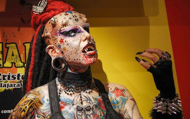 Tattooed figure with piercings and red hair at Ripley’s Believe It or Not! attraction.