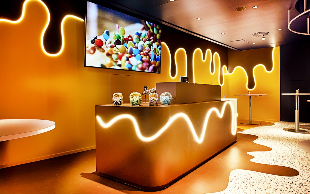 Chocoversum interior with chocolate-themed decor and candy jars, Hamburg.