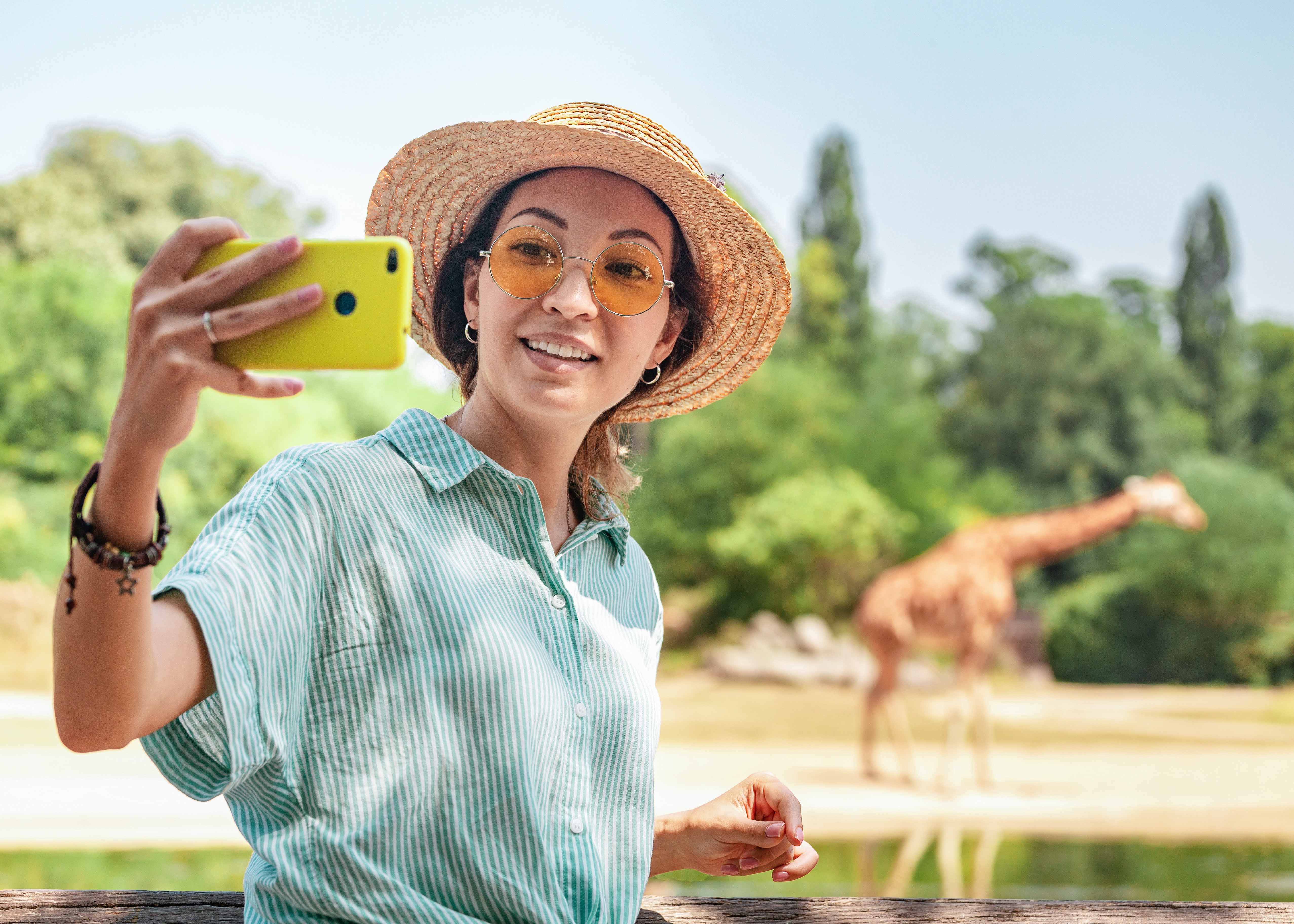 Zoo Miami entrance with visitors exploring pathways and viewing animal exhibits, Miami, Florida.