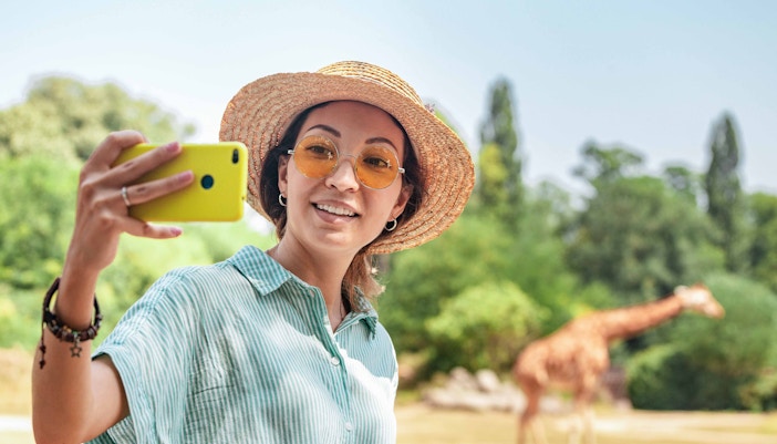 Zoo Miami entrance with visitors exploring pathways and viewing animal exhibits, Miami, Florida.