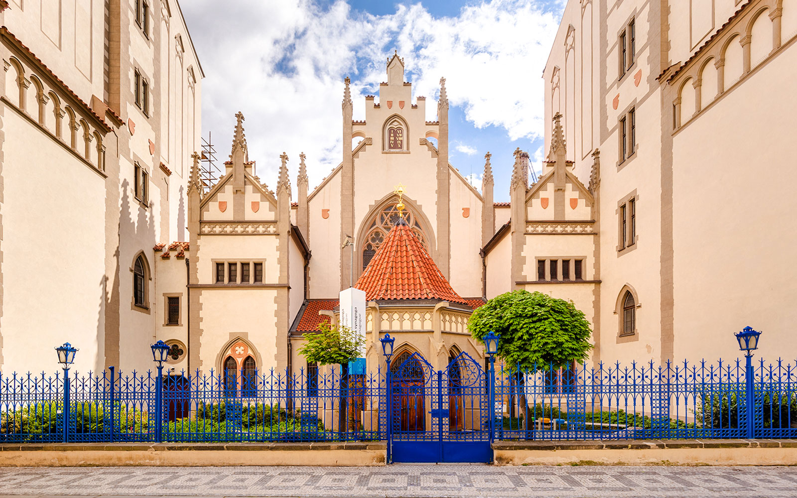 Maisel Synagogue in Prague with Gothic architecture and blue fence.