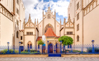 Maisel Synagogue in Prague with Gothic architecture and blue fence.