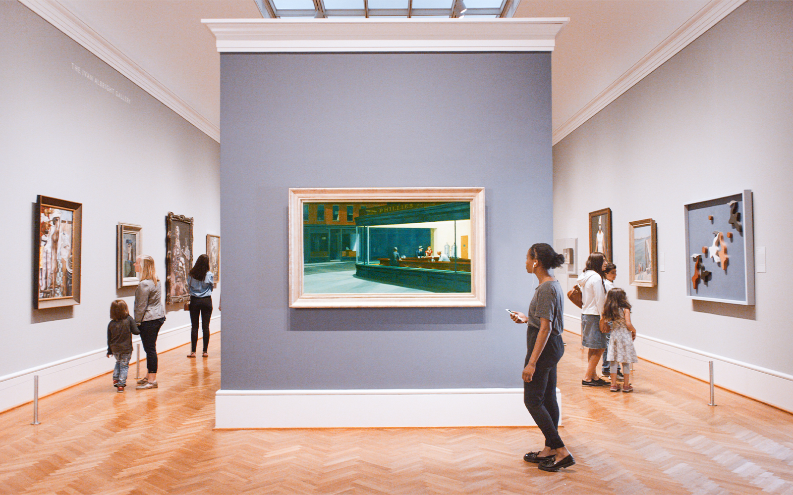 Visitors viewing paintings at The Art Institute of Chicago gallery.