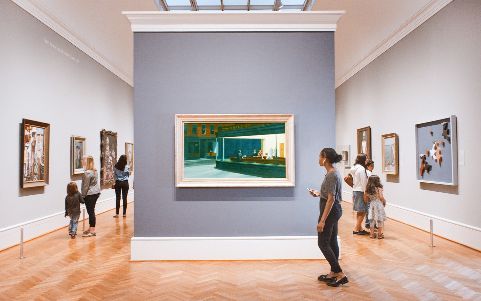 Visitors viewing paintings at The Art Institute of Chicago gallery.