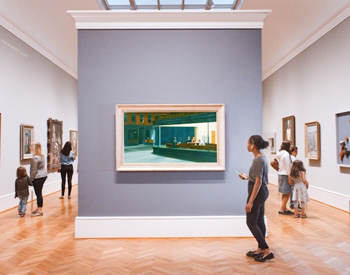 Visitors viewing paintings at The Art Institute of Chicago gallery.