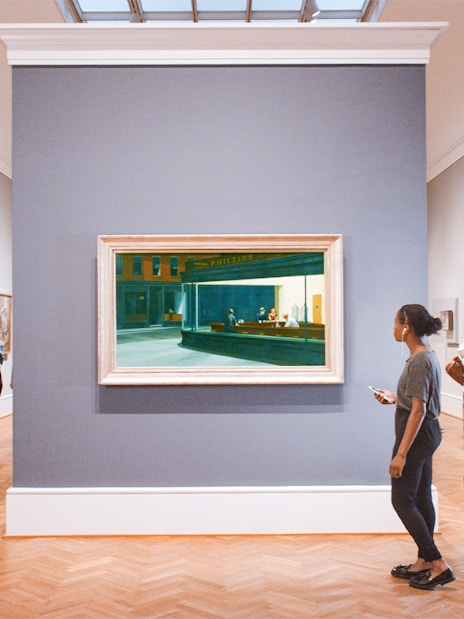 Visitors viewing paintings at The Art Institute of Chicago gallery.
