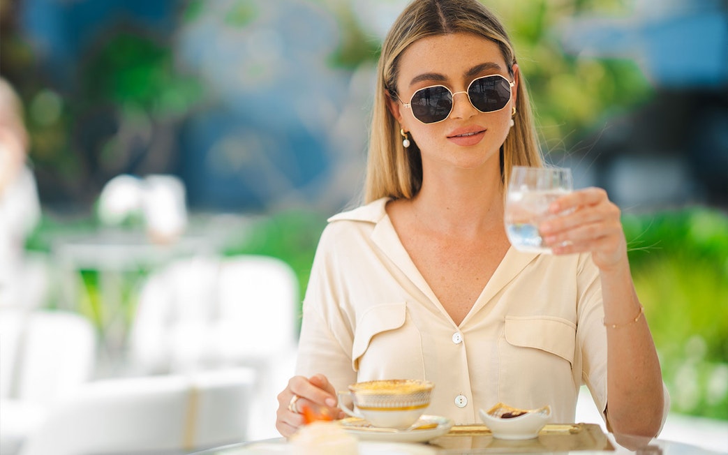 Guest enjoying a beverage during a guided tour inside Burj Al Arab.