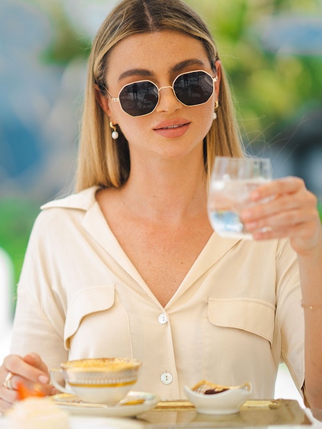Guest enjoying a beverage during a guided tour inside Burj Al Arab.