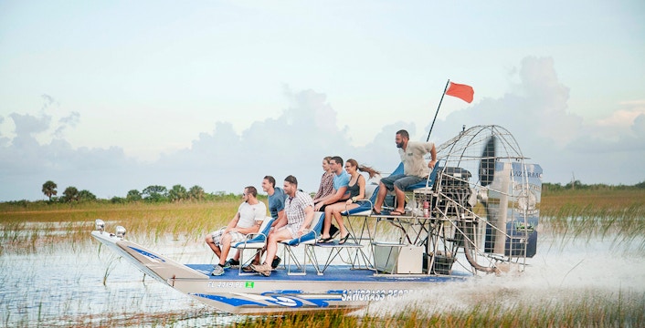 Airboat gliding through Everglades wetlands during private 1-hour adventure tour in Miami
