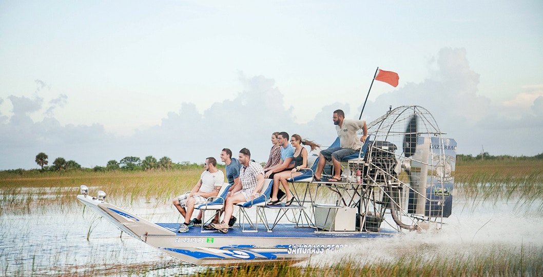 Airboat gliding through Everglades wetlands during private 1-hour adventure tour in Miami