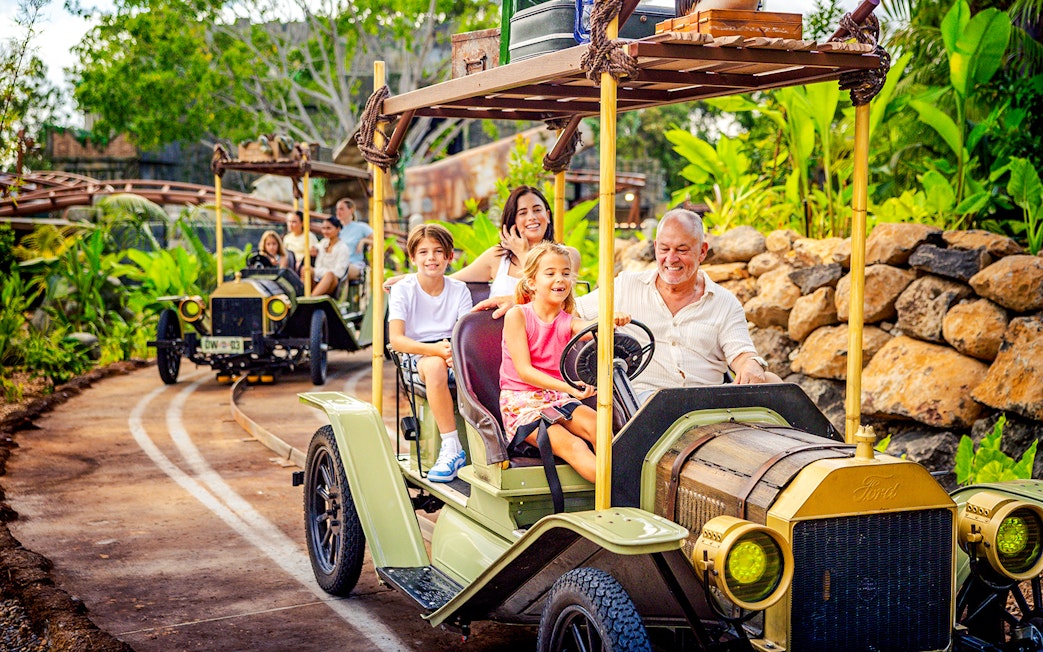 Family enjoying vintage car ride at Rivertown, Dreamworld, Gold Coast.