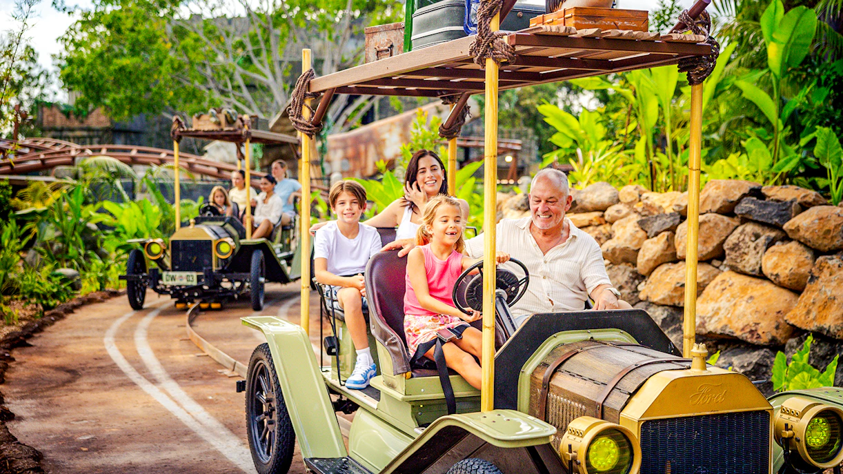 Family enjoying vintage car ride at Rivertown, Dreamworld, Gold Coast.