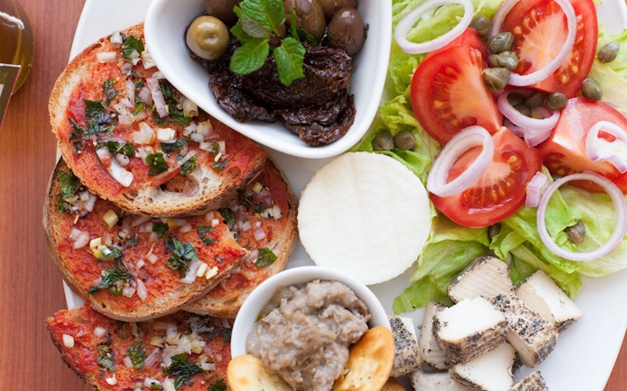 Traditional Maltese platter with bruschetta, olives, cheese, and salad at Limestone Heritage Park & Gardens.