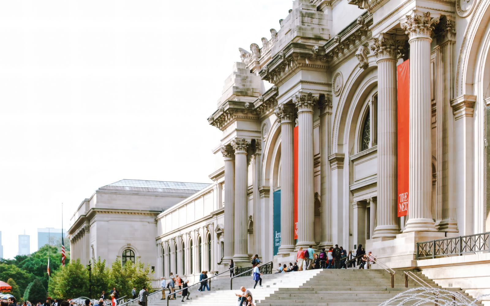 The Metropolitan Museum of Art exterior in New York with visitors on the steps.