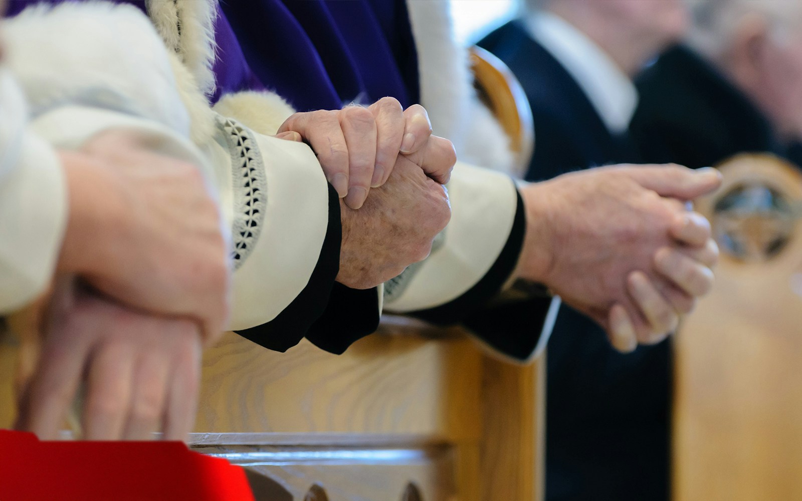Priests conducting prayer in a church during mass.