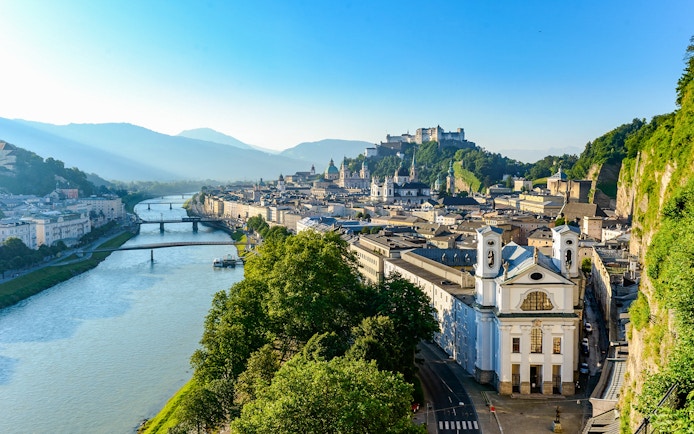 Salzburg cityscape with Hohensalzburg Fortress and Salzach River, view from above.