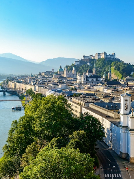 Salzburg cityscape with Hohensalzburg Fortress and Salzach River, view from above.