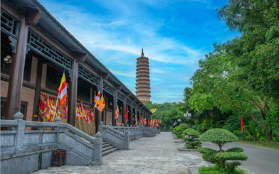 Bai Dinh Pagoda at twilight with flags and trees, Ninh Binh, Vietnam.