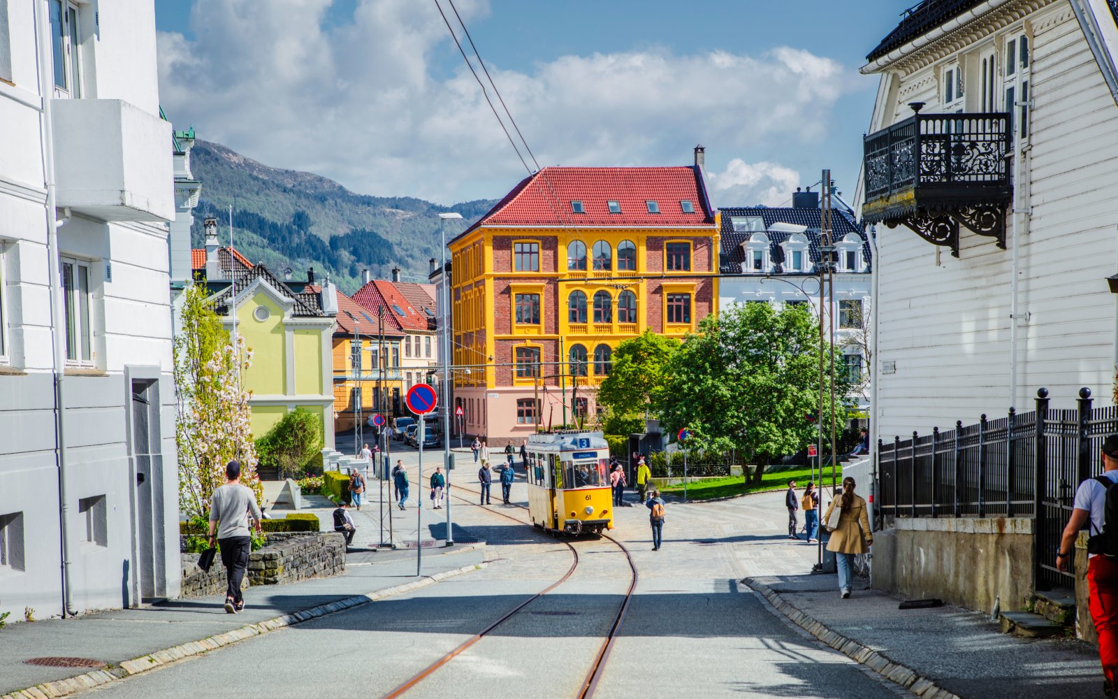 Street scene with tram and colorful buildings in Bergen, Norway.