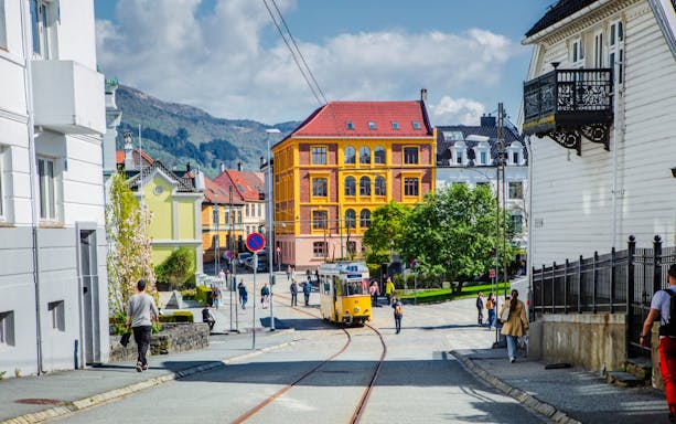 Street scene with tram and colorful buildings in Bergen, Norway.