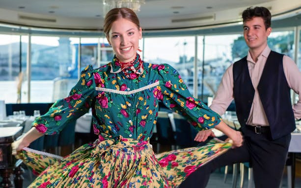 Traditional dancers performing on an evening Danube cruise in Budapest.