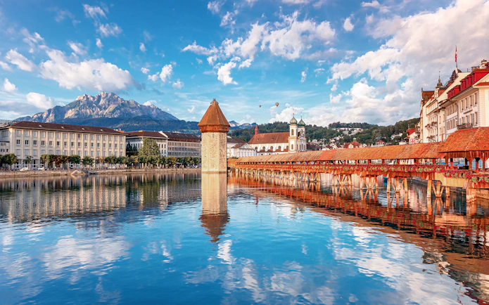 Chapel Bridge and Water Tower reflecting in Lake Lucerne, Switzerland.