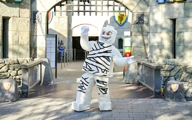 Mummy-themed Lego character at Legoland Billund entrance during Halloween event.