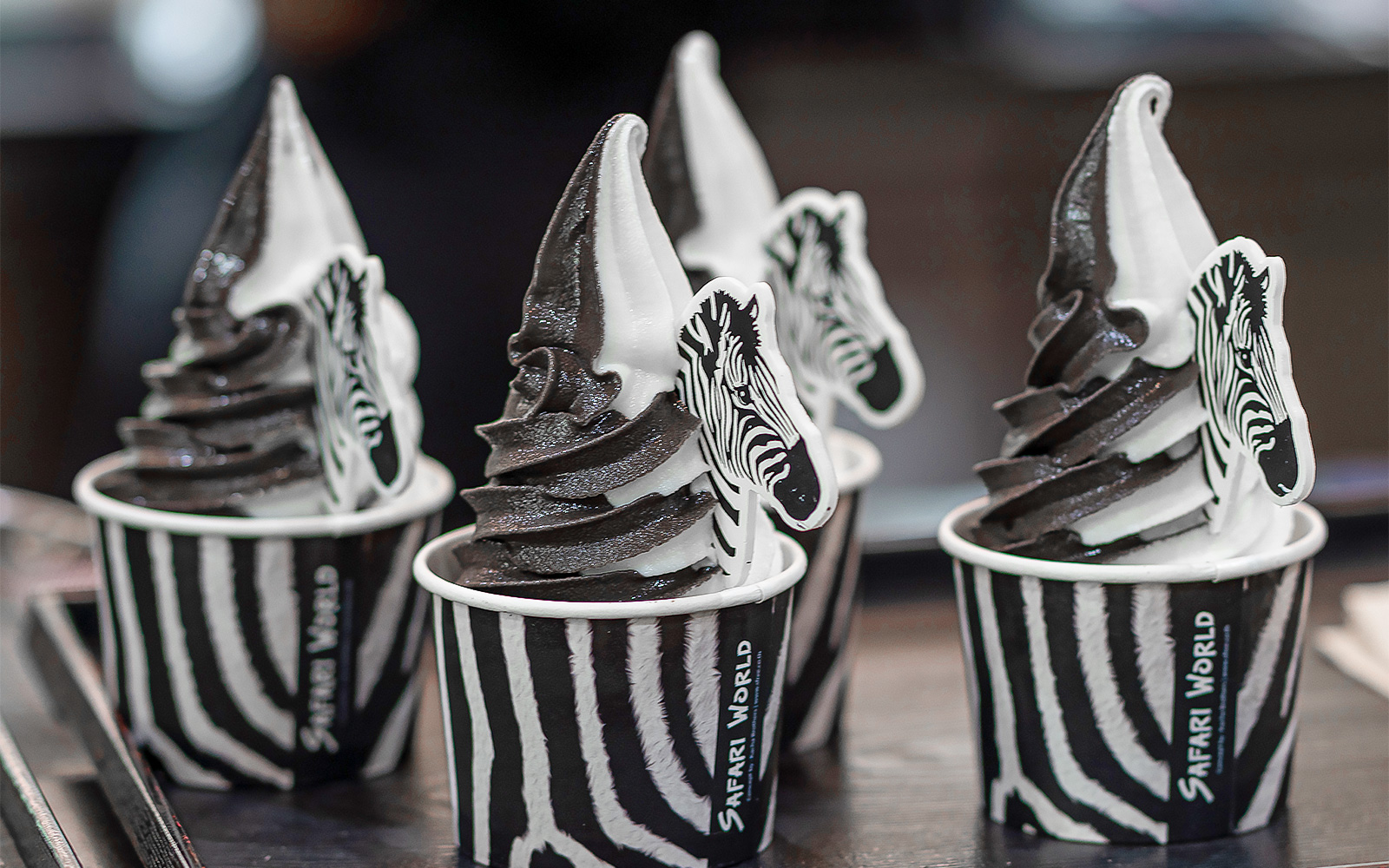 Safari World Bangkok entrance with visitors and animal sculptures, Bangkok, Thailand.