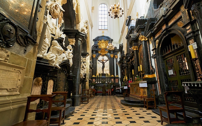 Interior of Wawel Cathedral with ornate altar and sculptures in Kraków, Poland.