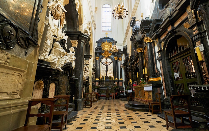 Interior of Wawel Cathedral with ornate altar and sculptures in Kraków, Poland.