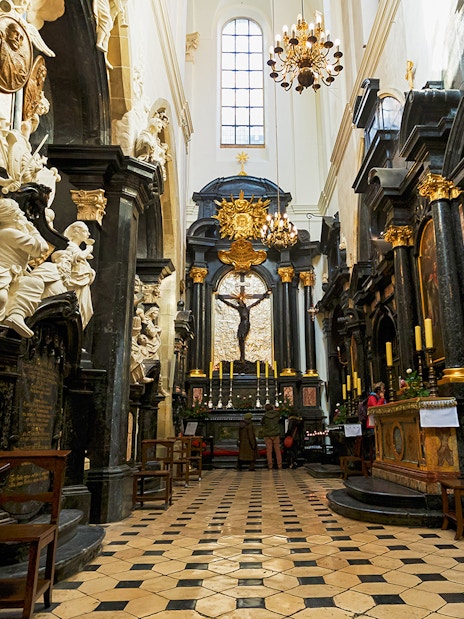 Interior of Wawel Cathedral with ornate altar and sculptures in Kraków, Poland.
