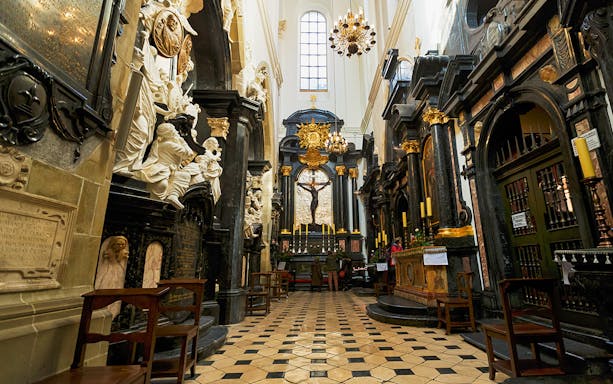 Interior of Wawel Cathedral with ornate altar and sculptures in Kraków, Poland.