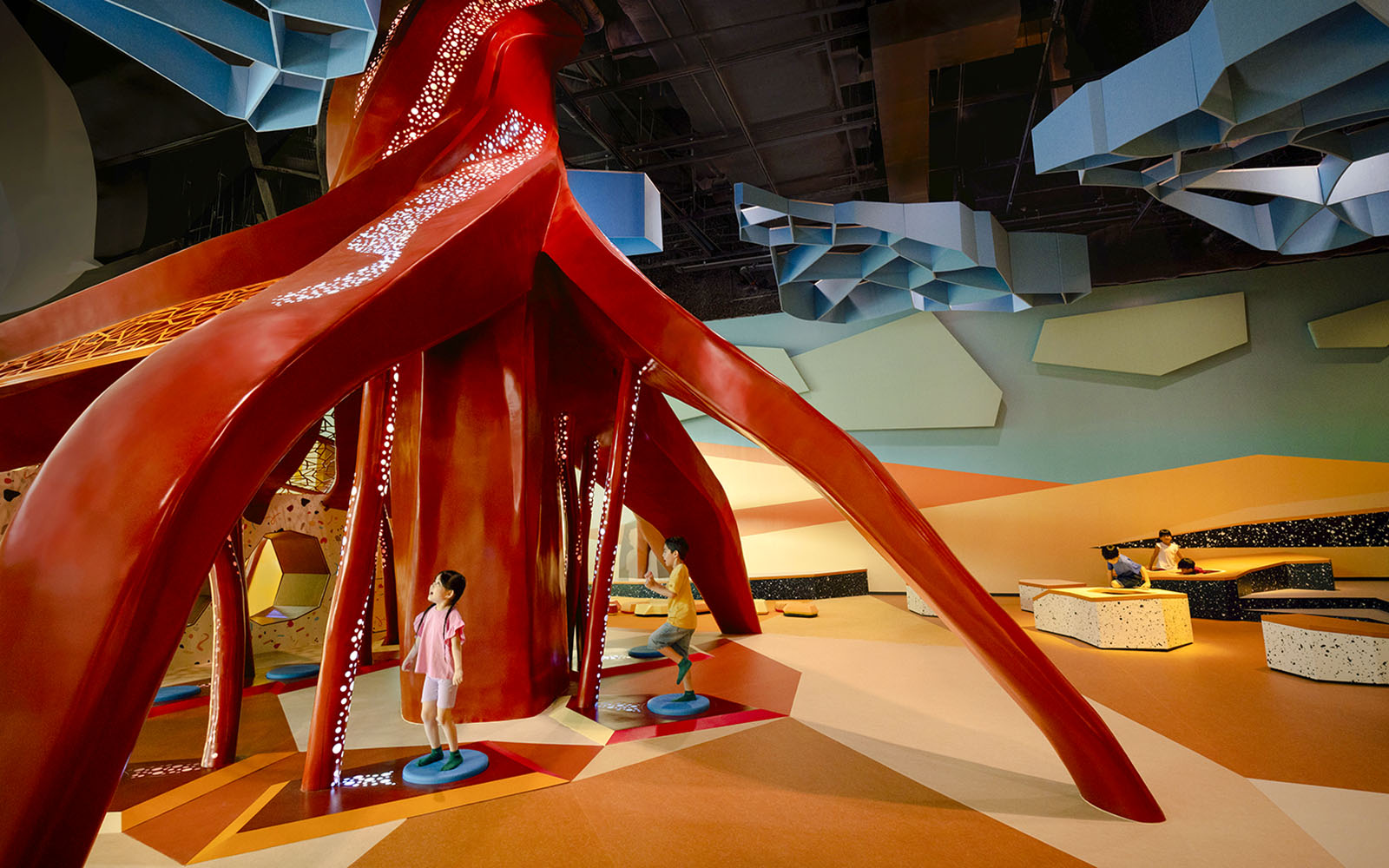 Children exploring the interactive Ancient Root exhibit at Curiosity Cove Dryland.