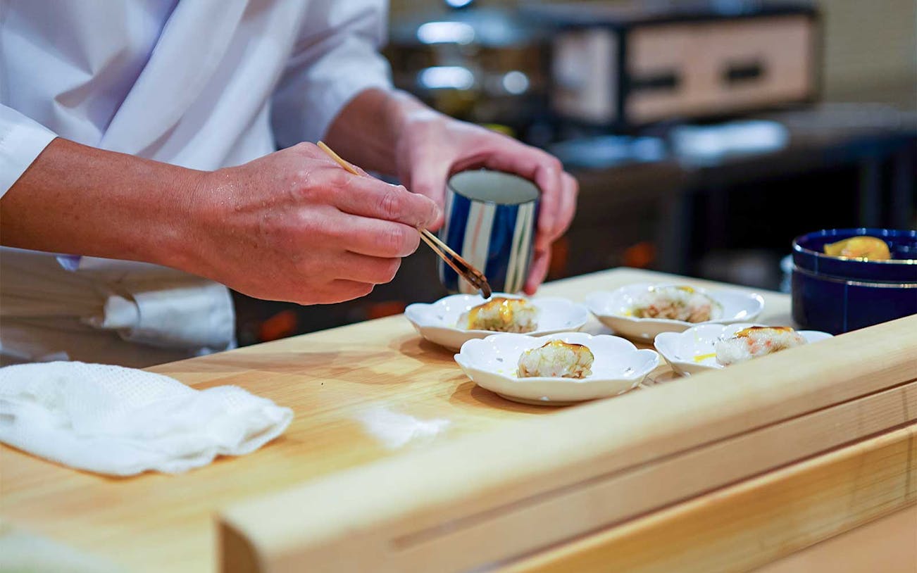 Chef preparing sushi omakase at Sushi Kurusu in Tokyo.