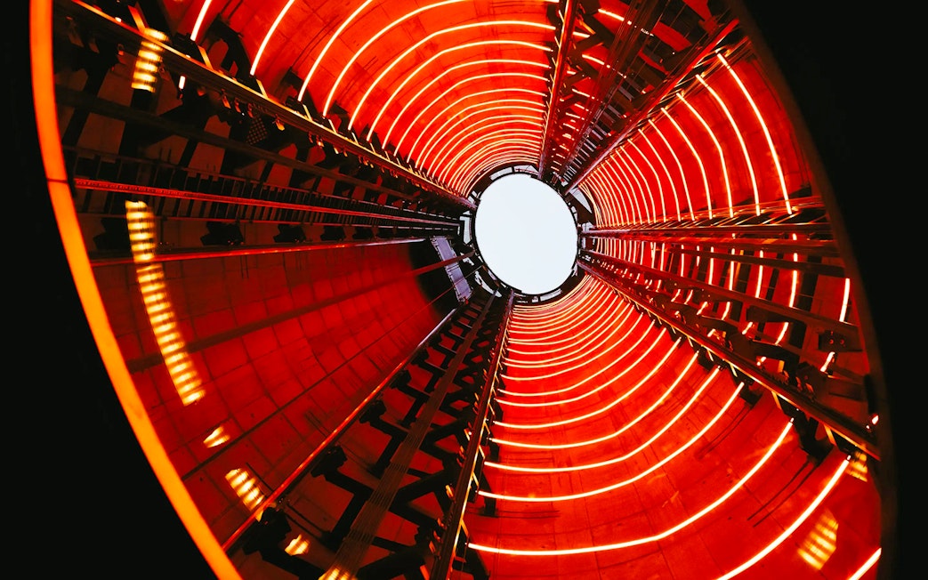 View from inside Lift 109 at Battersea Power Station with red neon lights.