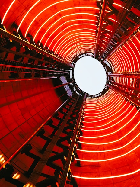 View from inside Lift 109 at Battersea Power Station with red neon lights.