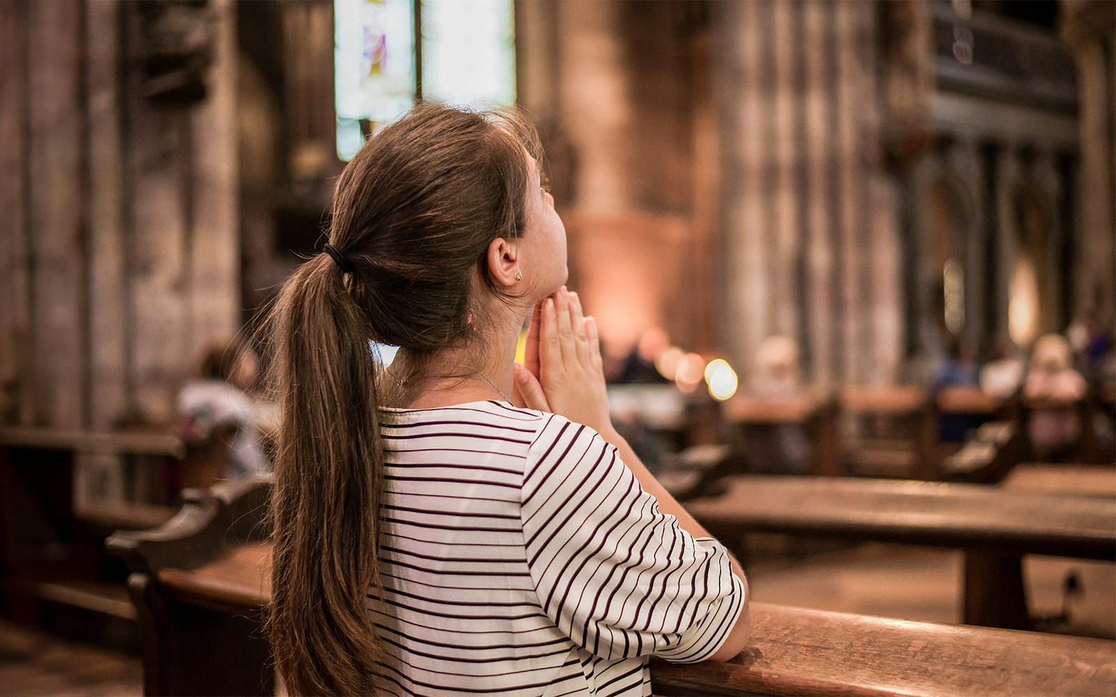woman praying in chapel