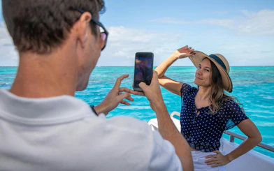 Person posing for a photo on a boat during a Cairns snorkeling tour.