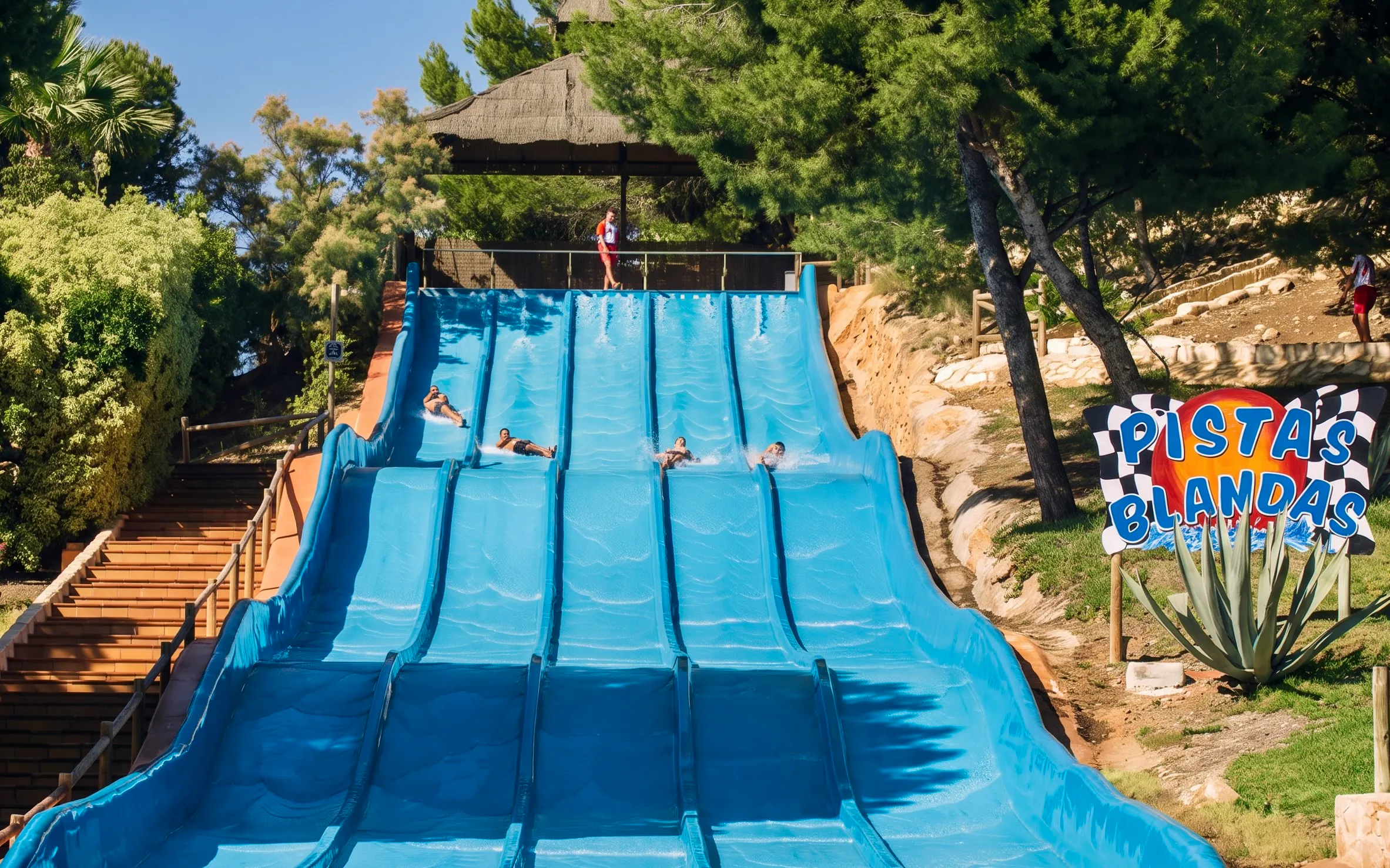 Aqualandia Benidorm water slide with people sliding down in Spain.